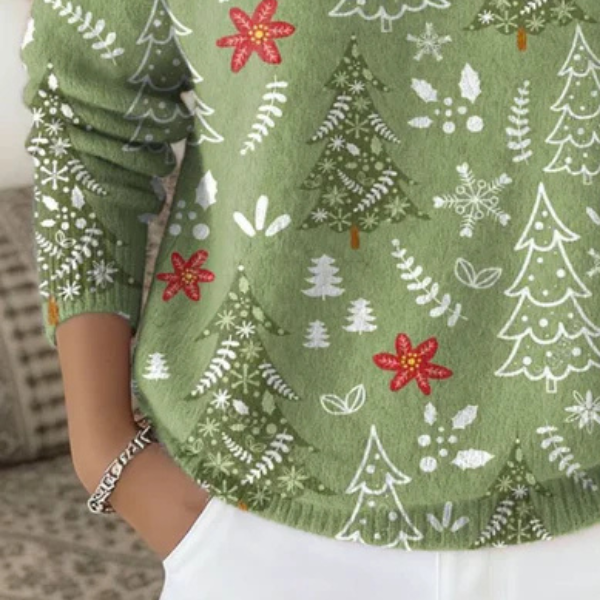 Green knit turtleneck sweater close-up with tree, snowflake, and red bow pattern