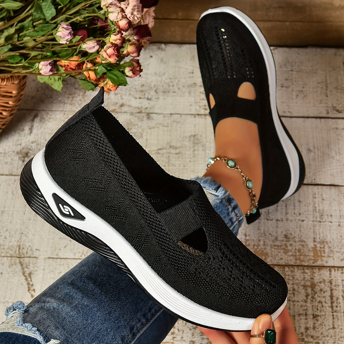 Black knit slip-on shoes with side cutouts and white sole