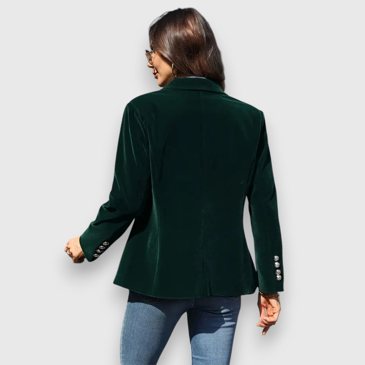 Women’s green blazer shown from the back with long sleeves and button cuffs