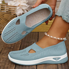 Light blue knit slip-on sneakers with side cutouts and white cushioned sole