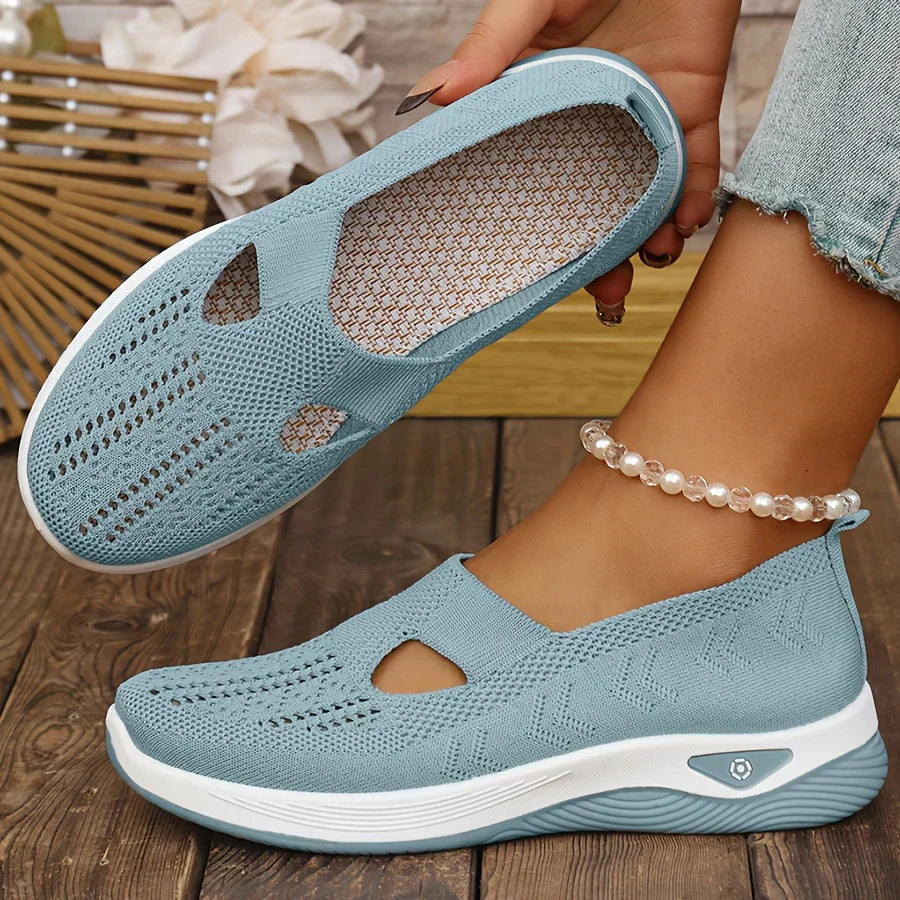 Light blue knit slip-on sneakers with side cutouts and white cushioned sole
