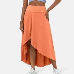 Asymmetric midi skirt in coral orange with high-low hem and draped side panel
