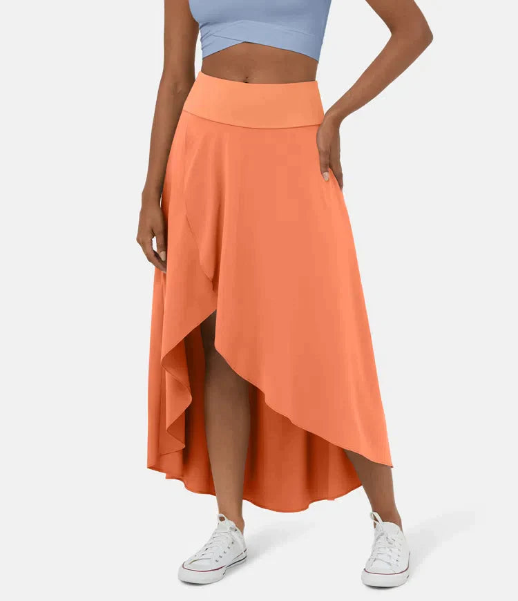 Asymmetric midi skirt in coral orange with high-low hem and draped side panel