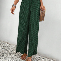 Green wide-leg trousers with shirred waist, repeating micro pattern, full length.