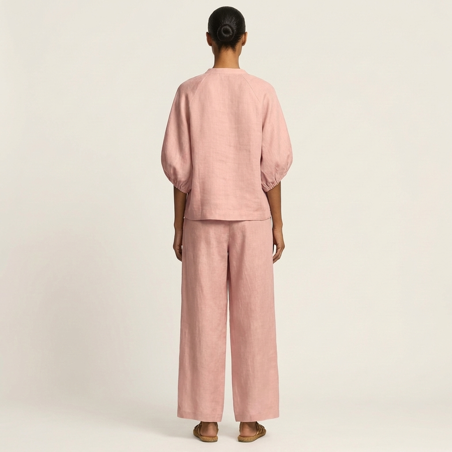 Pink zipper-front puff sleeve set, back view with wide-leg pants
