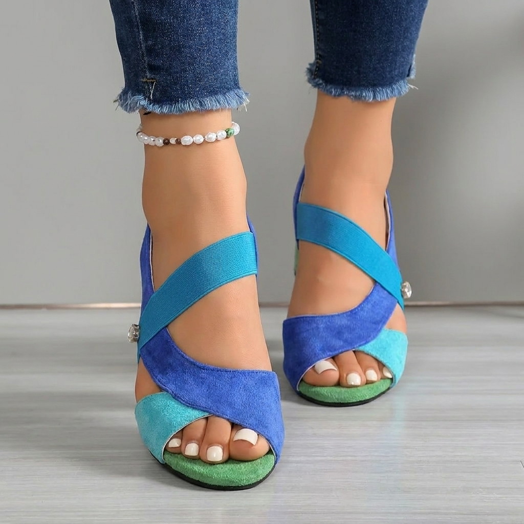 Blue block-heel sandals with ankle strap, crossed upper straps, and silver stud