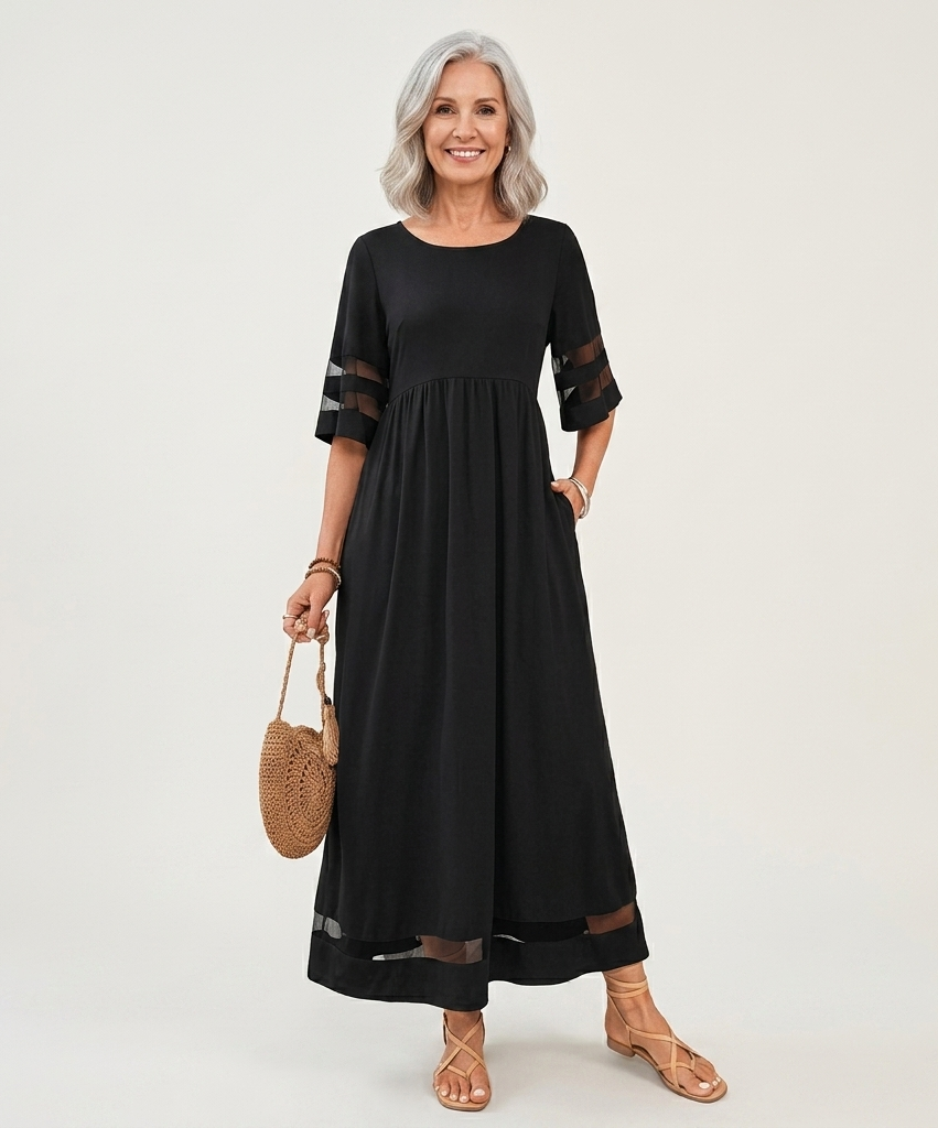 Black midi dress with sheer sleeve cutouts and gathered waist, dark hem trim