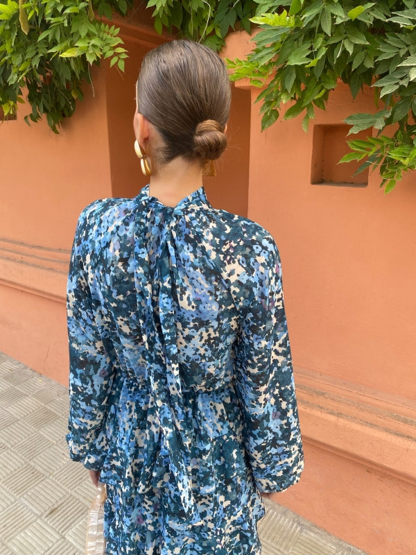 Blue floral midi dress back view with high neck, long sleeves, and tiered hem