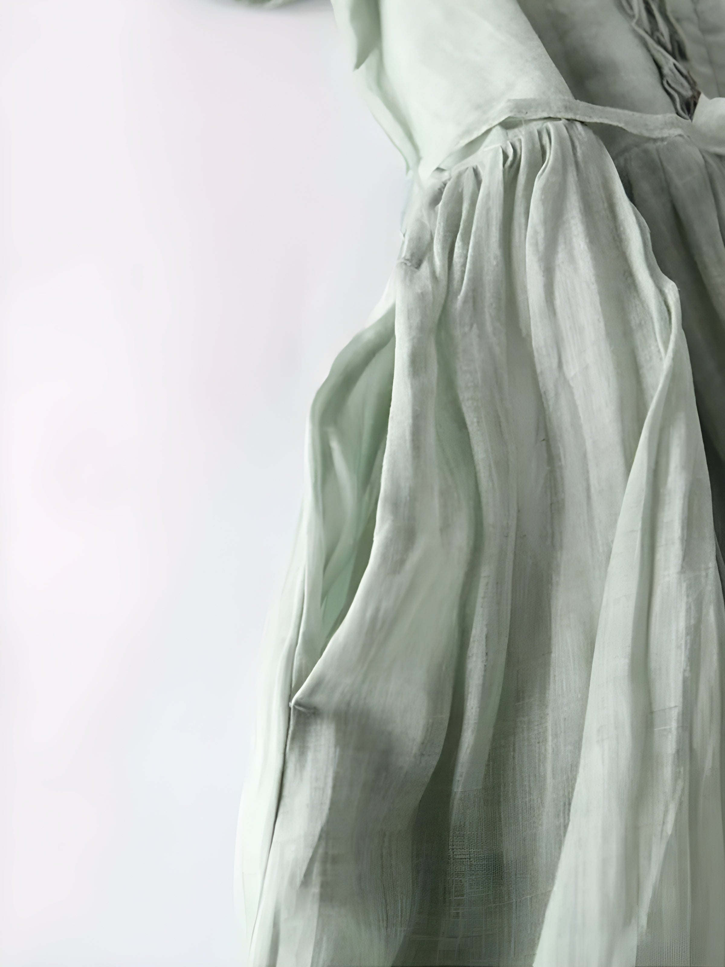 Sage green Amara vintage dress close-up: gathered skirt with tied waist and soft drape