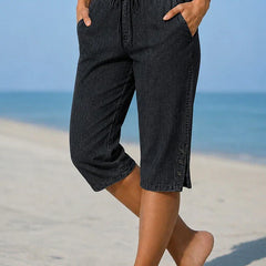Black calf-length capri trousers with drawstring waist and side button details