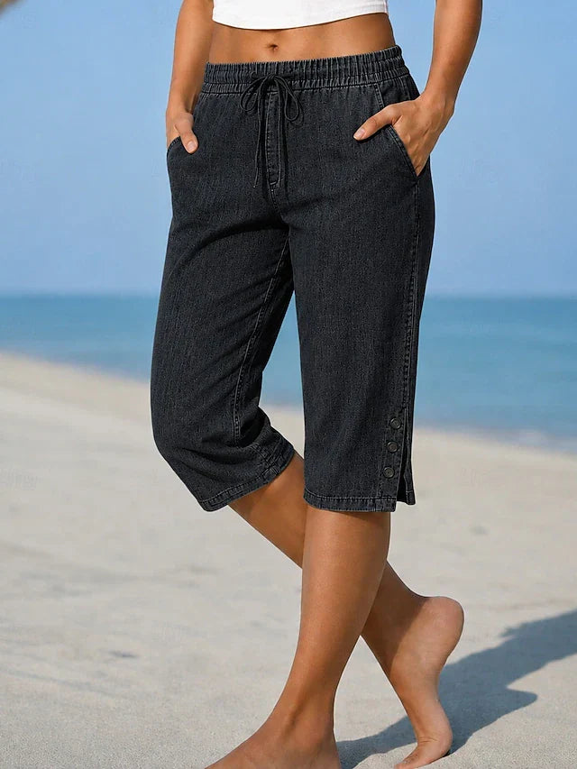 Black calf-length capri trousers with drawstring waist and side button details