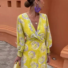 Yellow wrap midi dress with V-neck, long puff sleeves, and purple floral print