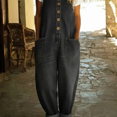 Black denim overalls with button front, chest pocket, and relaxed wide-leg silhouette