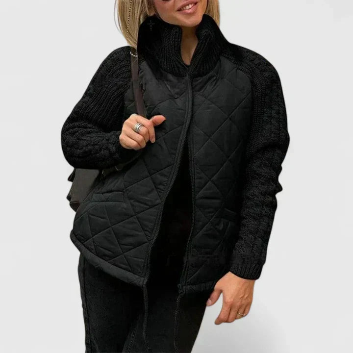 Quilted zip-up jacket in black with knit sleeves and stand collar