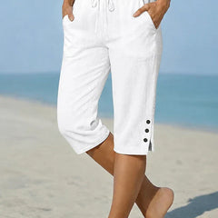 White calf-length capri trousers with drawstring waist and side button details