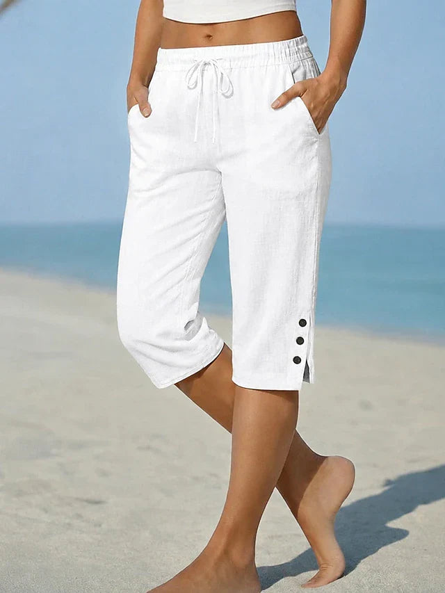 White calf-length capri trousers with drawstring waist and side button details