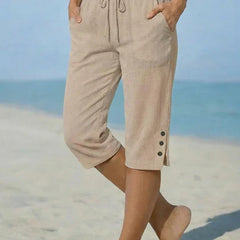 Beige calf-length capri trousers with drawstring waist and side button details